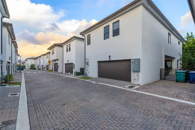 an aerial view of residential houses with city view