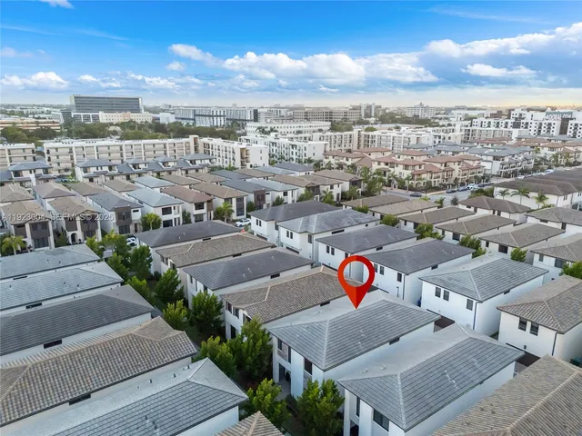 an aerial view of residential houses with outdoor space
