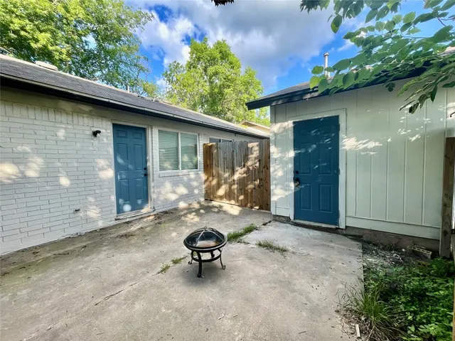 a view of a patio with table and chairs and potted plants