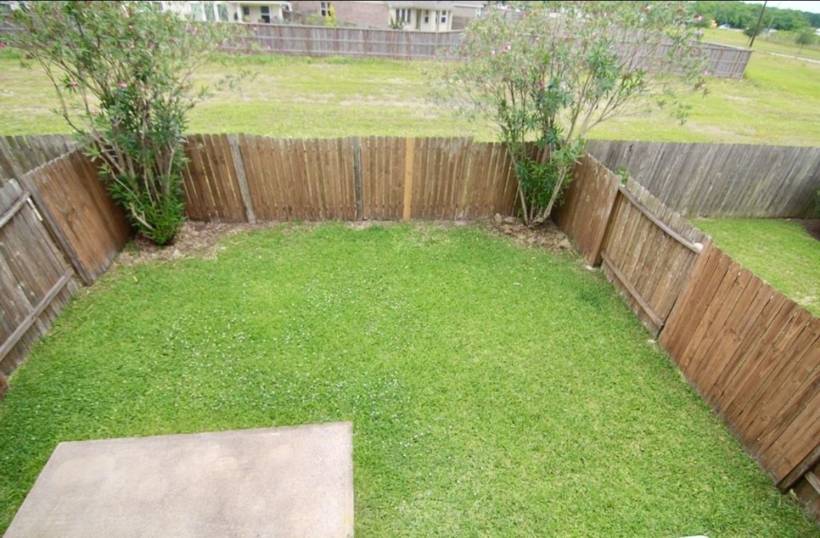 11834 Ramla Place Trail Houston, TX 77089 - Photo 24 of 30 a view of backyard with green space and wooden fence