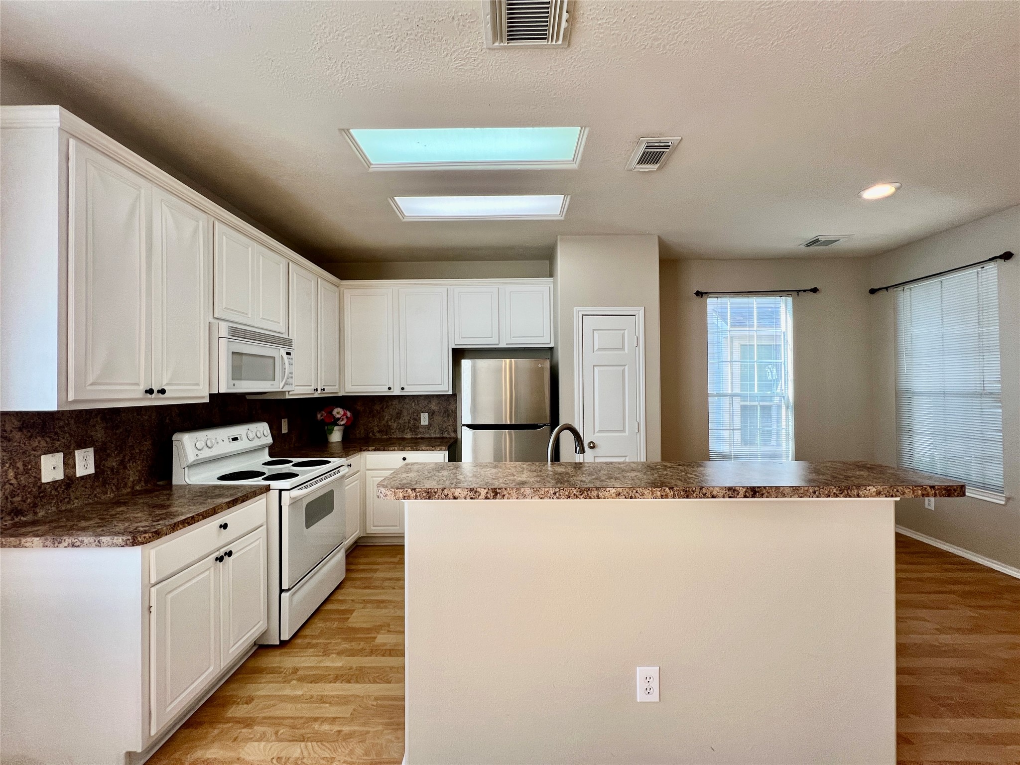 11834 Ramla Place Trail Houston, TX 77089 - Photo 9 of 30 a kitchen with stainless steel appliances granite countertop a sink a stove and a refrigerator