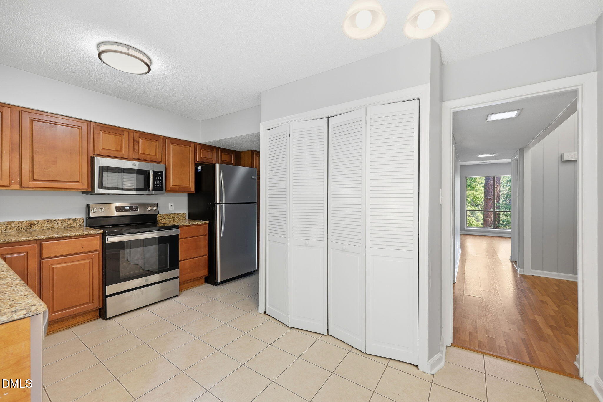 5043 Tall Pines Court Raleigh, NC 27609 - Photo 5 of 37 a kitchen with stainless steel appliances granite countertop a refrigerator and a stove top oven