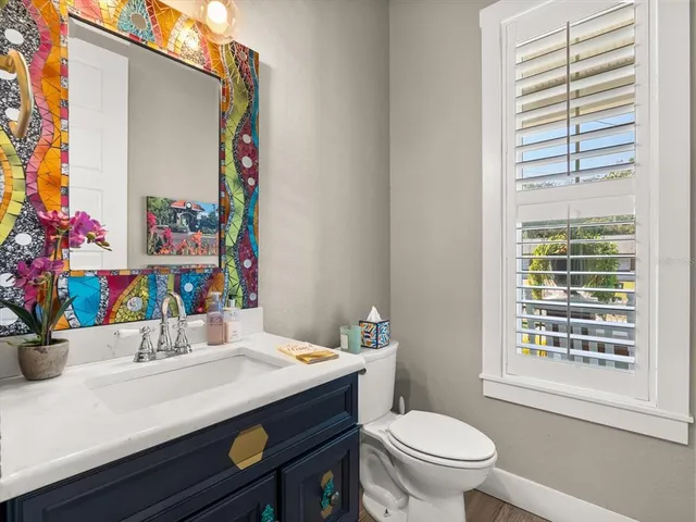 a bathroom with a sink a toilet and a window