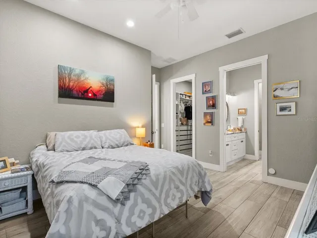 a bedroom with a bed and a painting on the wall