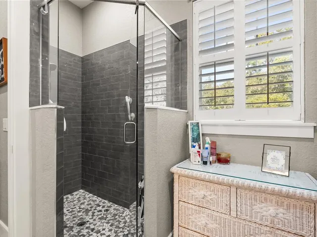 a bathroom with a shower and a sink