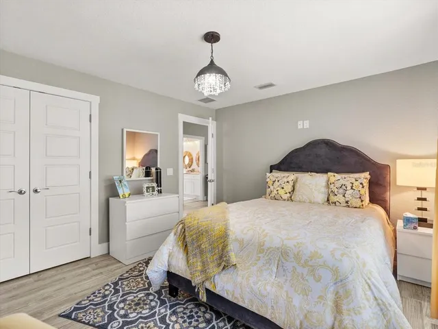 a bedroom with a bed and a mirror