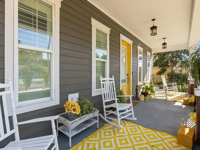 a balcony with furniture and a potted plant