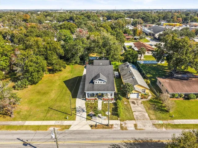 an aerial view of residential houses with yard