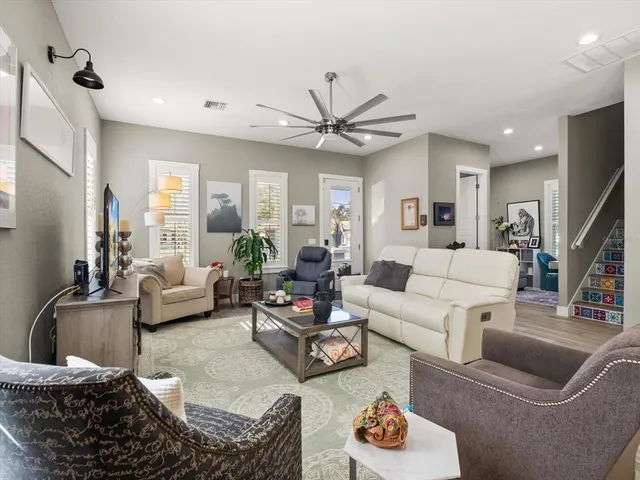 a living room with furniture ceiling fan and a rug