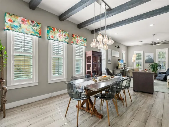 a view of a dining room with furniture and a large window
