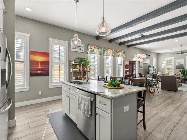 a kitchen with a counter space a sink appliances and cabinets