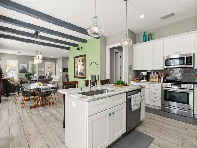 a kitchen with a sink stove and cabinets
