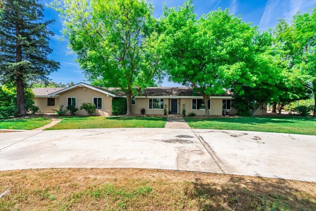 14066 Skyview Road Madera, CA 93636 - Photo 1 of 42 a house with a yard and a large tree