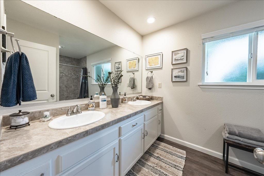 14066 Skyview Road Madera, CA 93636 - Photo 14 of 42 a en suite bathroom with a granite countertop sink and a mirror