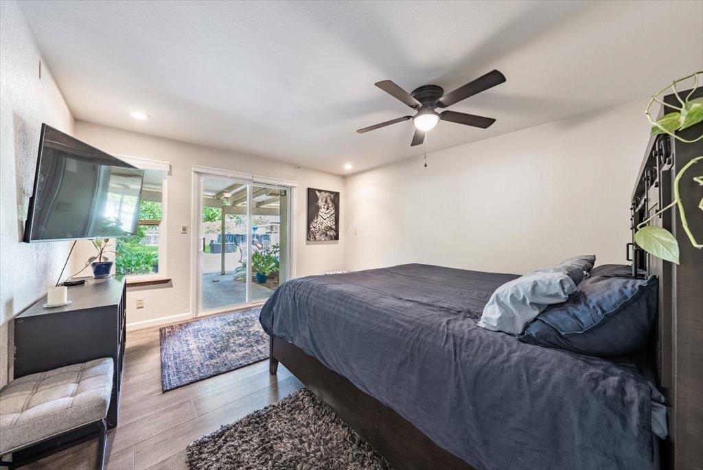 14066 Skyview Road Madera, CA 93636 - Photo 16 of 42 a bed sitting in a bedroom next to a window with a flat screen tv and a couch