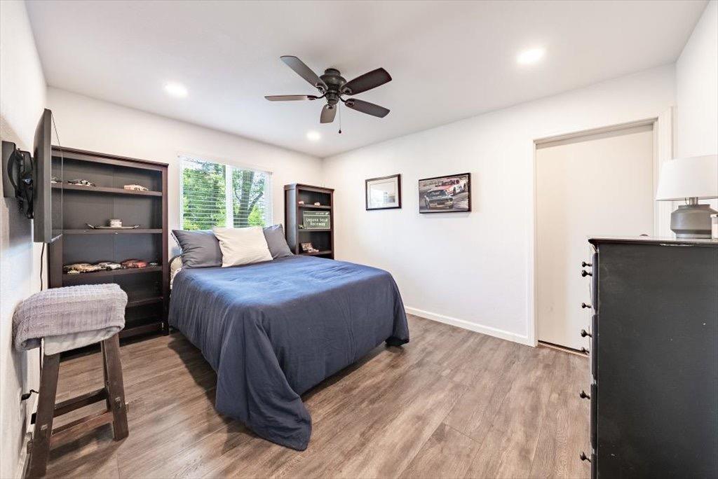 14066 Skyview Road Madera, CA 93636 - Photo 22 of 42 a spacious bedroom with a bed and wooden floor