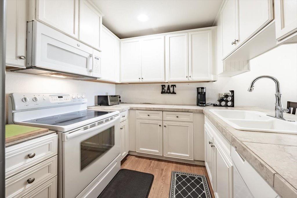14066 Skyview Road Madera, CA 93636 - Photo 24 of 42 a kitchen with cabinets appliances a sink and a counter top space