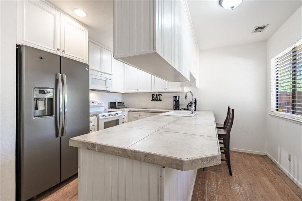 14066 Skyview Road Madera, CA 93636 - Photo 25 of 42 a kitchen with stainless steel appliances granite countertop a sink a microwave refrigerator and a window