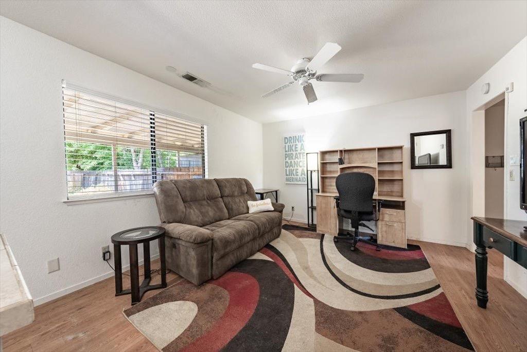 14066 Skyview Road Madera, CA 93636 - Photo 27 of 42 a living room with furniture a fireplace and a window
