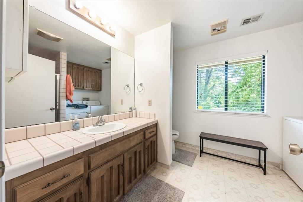 14066 Skyview Road Madera, CA 93636 - Photo 28 of 42 a bathroom with a sink and a mirror