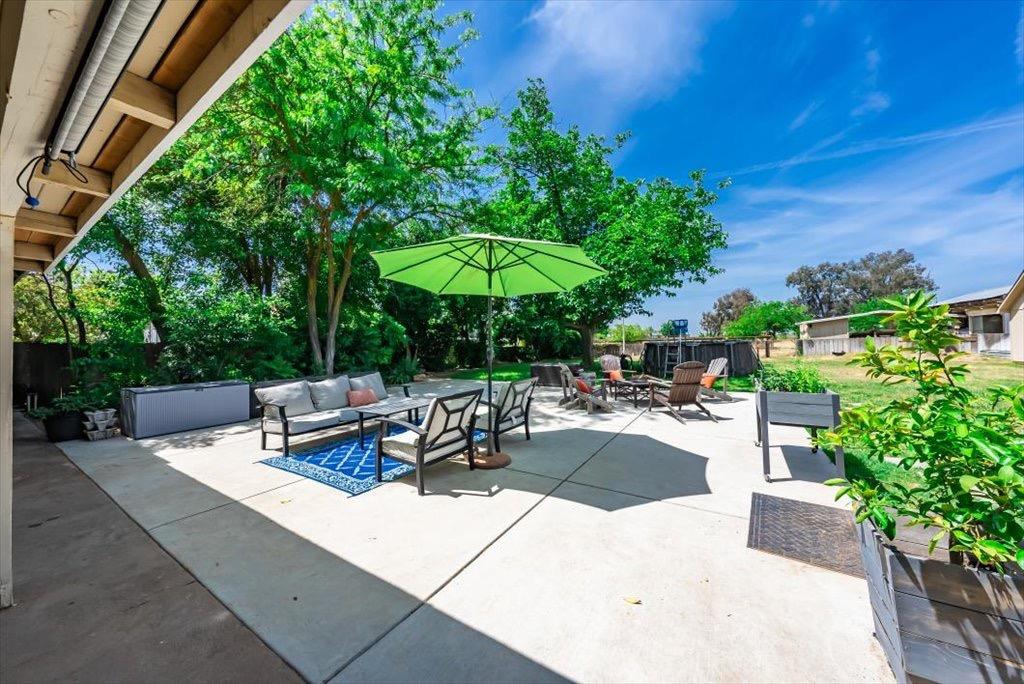 14066 Skyview Road Madera, CA 93636 - Photo 34 of 42 a view of a tables and chairs under an umbrella in patio