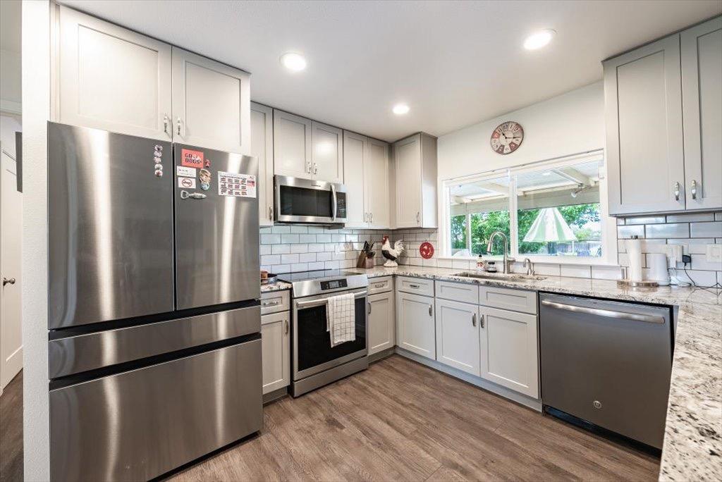 14066 Skyview Road Madera, CA 93636 - Photo 9 of 42 a kitchen with stainless steel appliances granite countertop a refrigerator stove microwave and sink