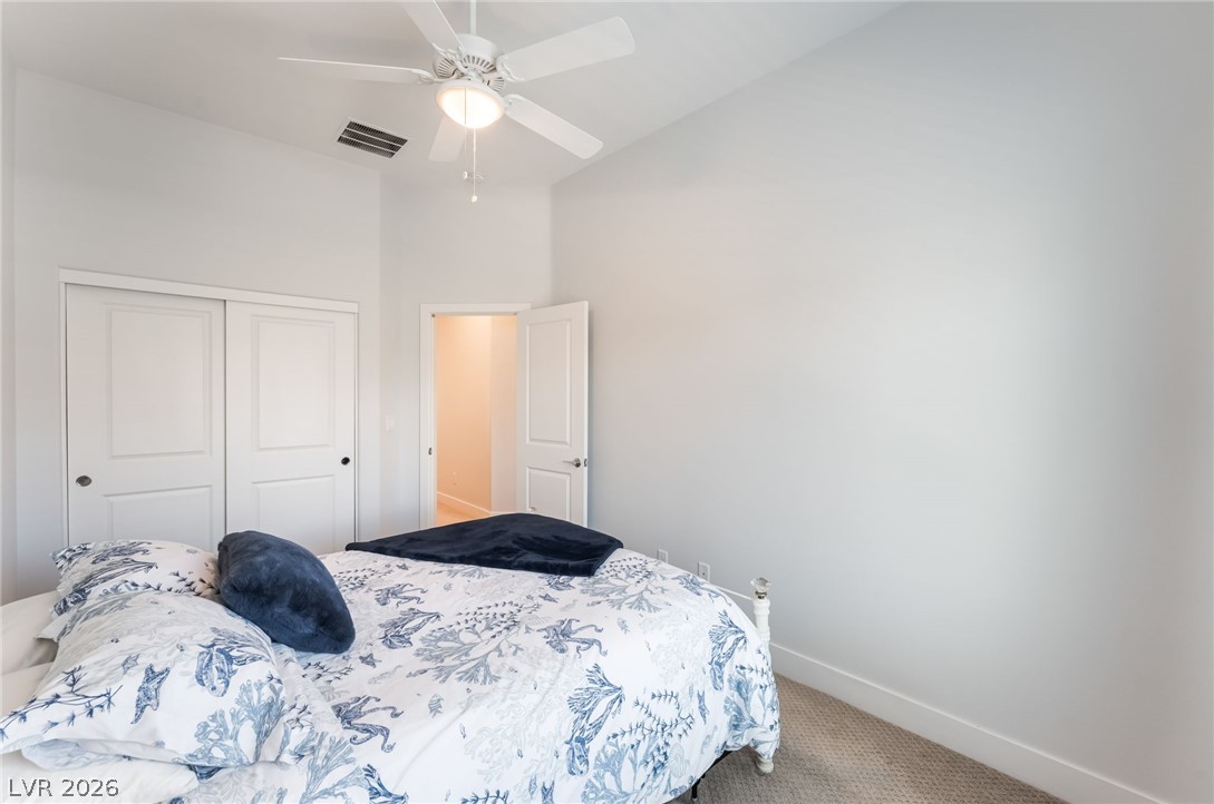 6432 Spring Jog Street Las Vegas, NV 89166 - Photo 34 of 61 Well-lit sleeping quarters with a vaulted ceiling and a dedicated closet for storage.
