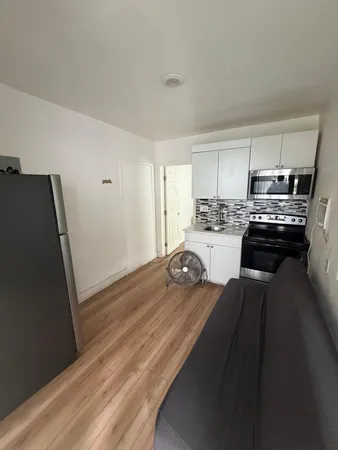 a kitchen with a sink a stove and refrigerator