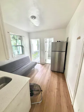 a bedroom with a bed and a mirror