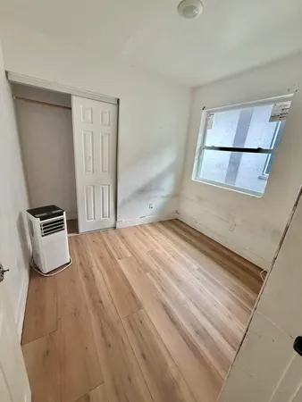 a view of a room with wooden floor