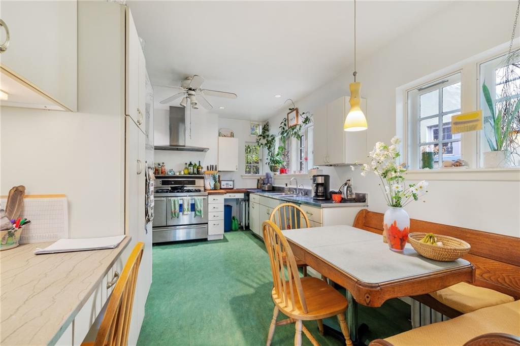 7008 Thomas Boulevard Pittsburgh, PA 15208 - Photo 7 of 23 a kitchen with a table chairs stove and refrigerator