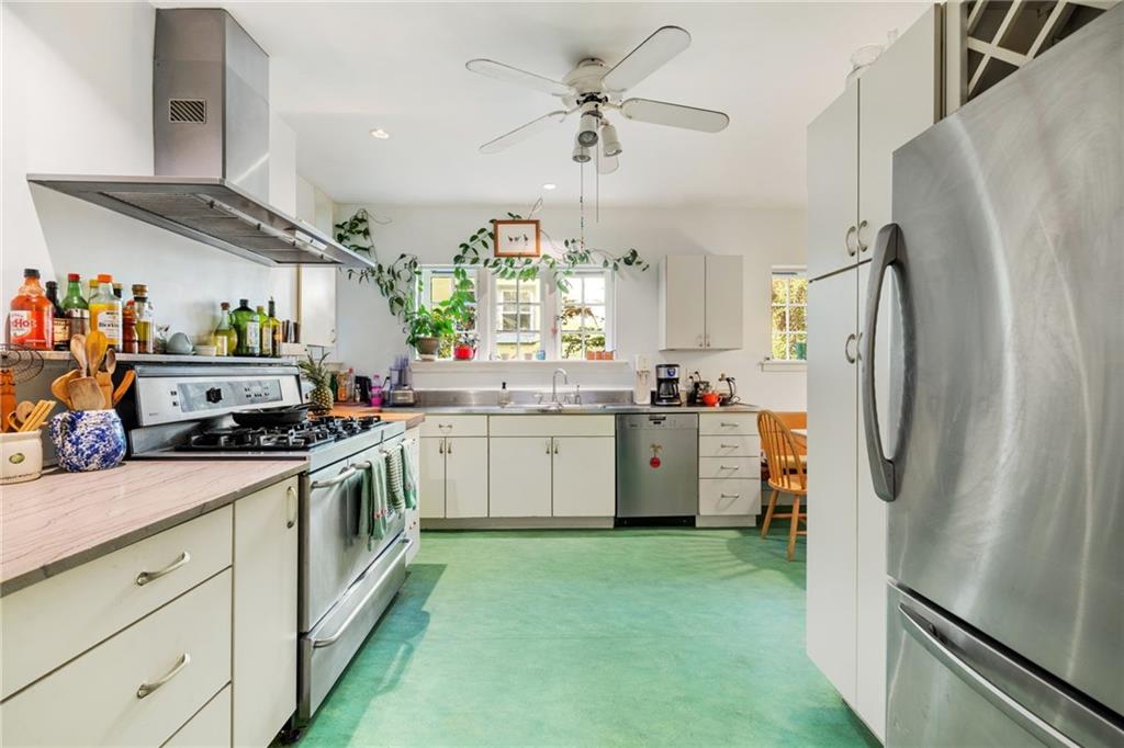 7008 Thomas Boulevard Pittsburgh, PA 15208 - Photo 8 of 23 a kitchen with a sink stainless steel appliances a refrigerator and cabinets