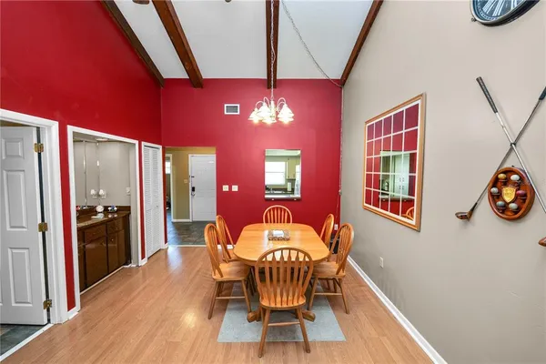 a dining room with furniture and wooden floor