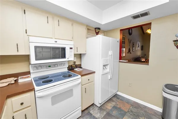 a kitchen with a stove and a refrigerator