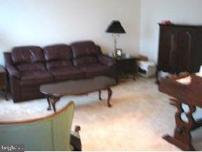 148 Barracuda Road Manahawkin, NJ 08050 - Photo 2 of 8 a living room with furniture and a lamp