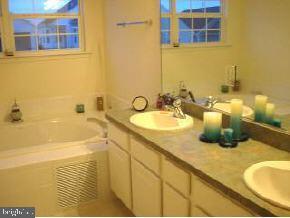 148 Barracuda Road Manahawkin, NJ 08050 - Photo 7 of 8 a bathroom with a granite countertop sink and a mirror