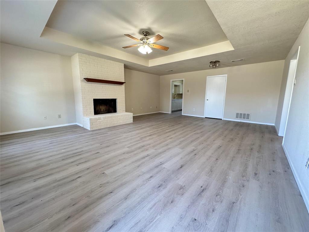 528 Post Oak Lane Allen, TX 75002 - Photo 3 of 19 a view of an empty room with wooden floor and a fireplace