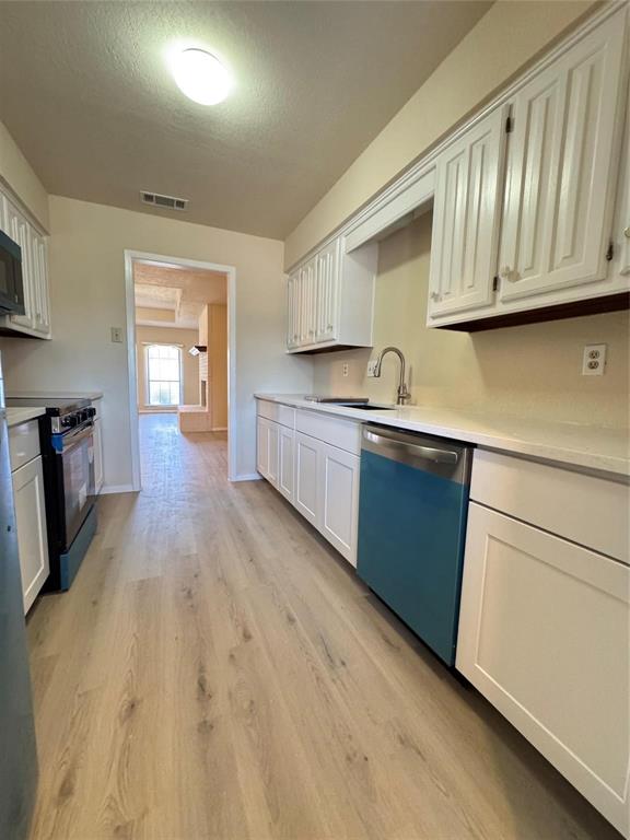 528 Post Oak Lane Allen, TX 75002 - Photo 7 of 19 a kitchen with wooden cabinets and sink