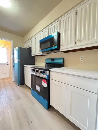a kitchen with stainless steel appliances granite countertop a refrigerator stove and microwave