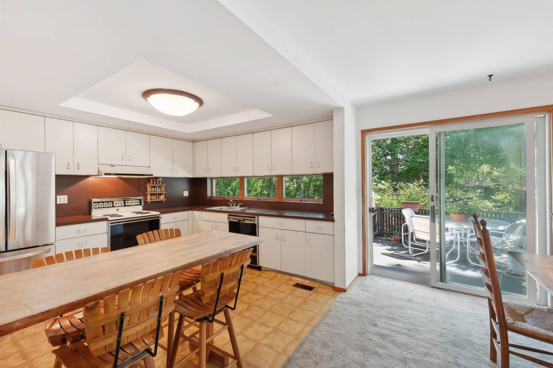 6 Eli Circle East Hampton, NY 11937 - Photo 8 of 29 a kitchen with a table chairs microwave and refrigerator