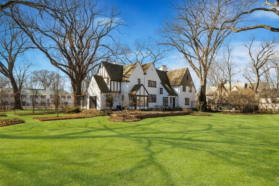 180 Dewindt Road Winnetka, IL 60093 - Photo 2 of 7 a white house with a big yard and large trees