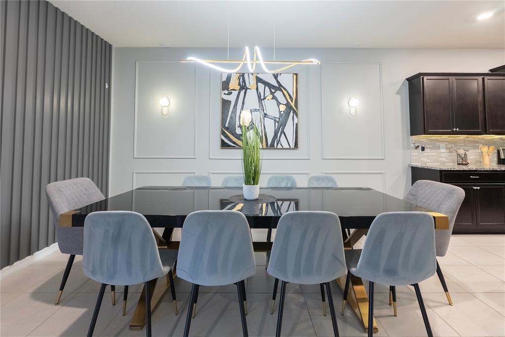 4425 Kaipo Road Davenport, FL 33897 - Photo 15 of 100 a view of a dining room with furniture and wooden floor