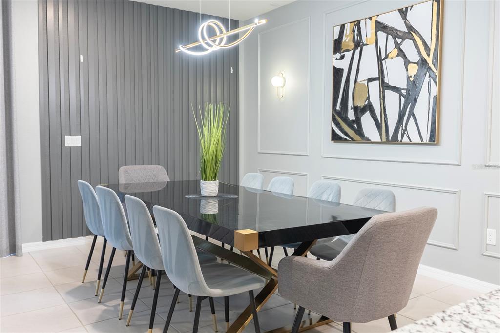 4425 Kaipo Road Davenport, FL 33897 - Photo 16 of 100 a view of a dining room with furniture and a potted plant