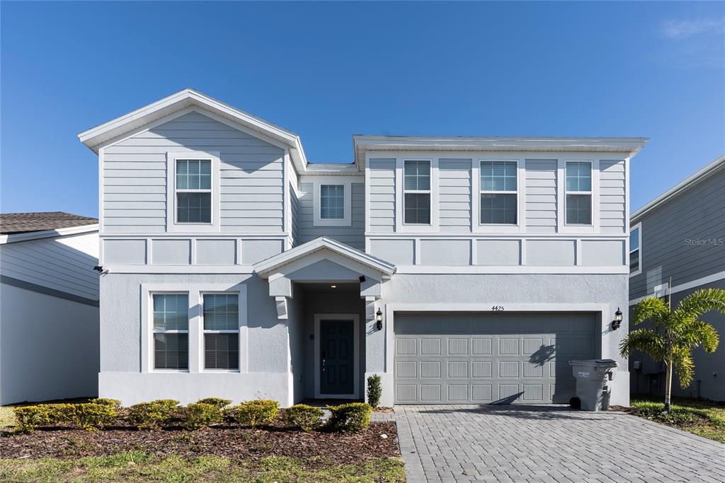 4425 Kaipo Road Davenport, FL 33897 - Photo 2 of 100 a front view of a house with garden