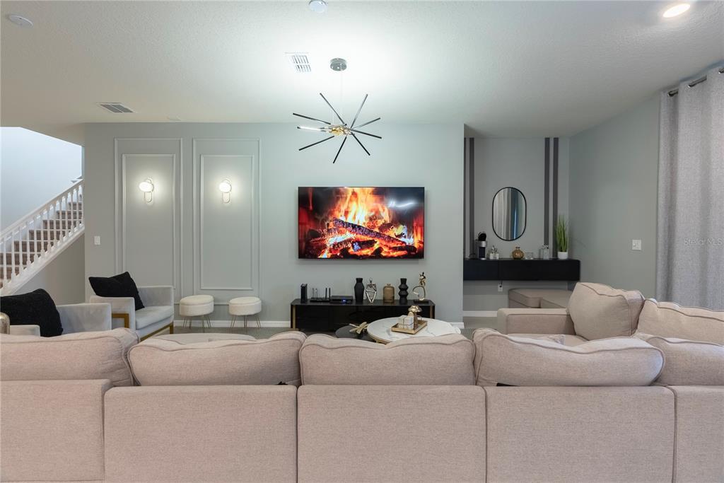 4425 Kaipo Road Davenport, FL 33897 - Photo 21 of 100 a living room with furniture and a flat screen tv