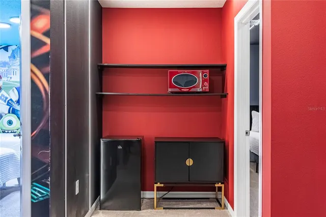 a view of a entryway with a flower pot and a bookshelf