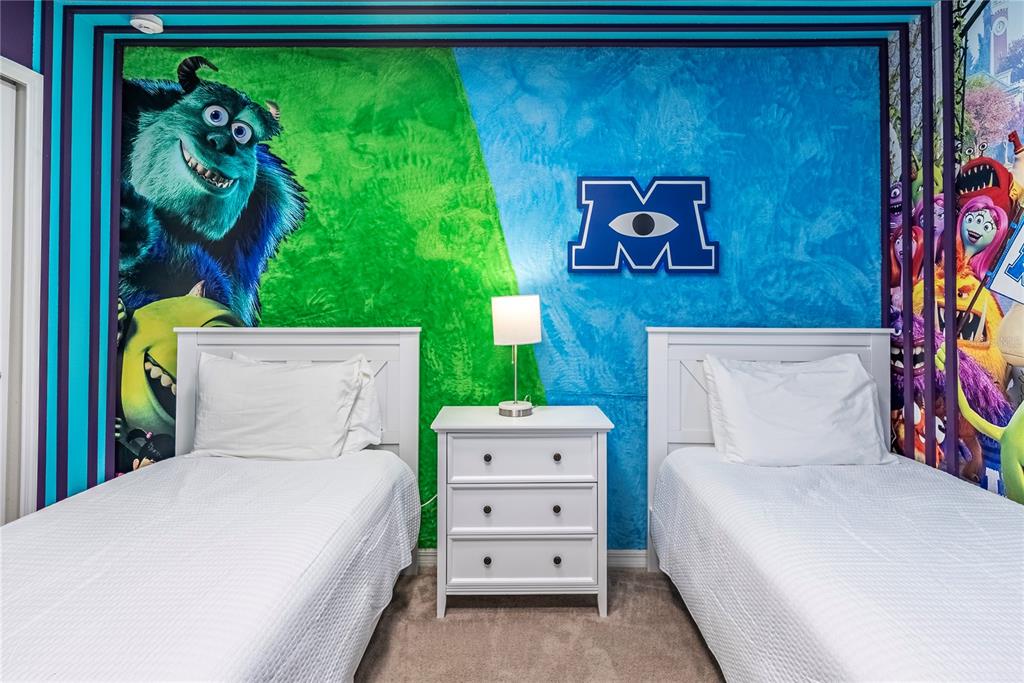 4425 Kaipo Road Davenport, FL 33897 - Photo 59 of 100 a bedroom with a bed and a painting on the wall