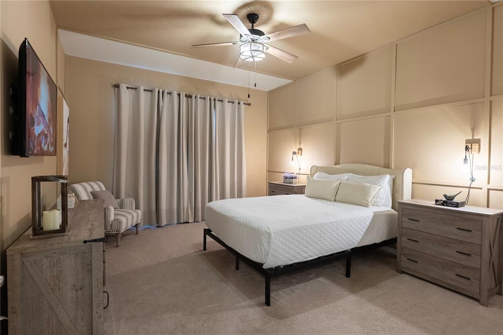 4425 Kaipo Road Davenport, FL 33897 - Photo 6 of 100 a spacious bedroom with a bed and a chandelier