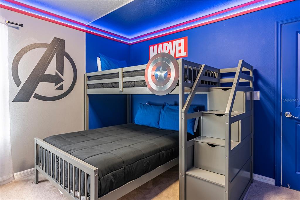 4425 Kaipo Road Davenport, FL 33897 - Photo 66 of 100 a bedroom with a bed and a mirror on the wall