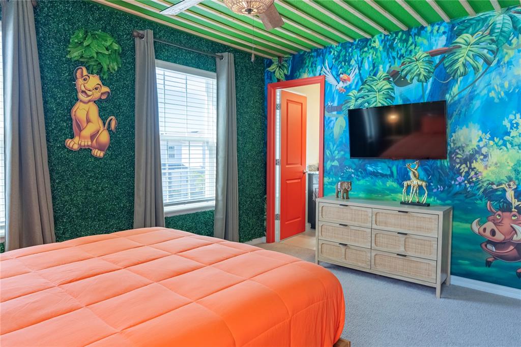 4425 Kaipo Road Davenport, FL 33897 - Photo 80 of 100 a bedroom with a bed and a flat screen tv